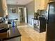 Functional kitchen featuring tile flooring, white cabinets, and stainless steel appliances at 310 S Butler Ave, Indianapolis, IN 46219