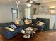 Inviting living room with a large sofa, fireplace with mantle, and hardwood floors at 310 S Butler Ave, Indianapolis, IN 46219