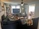 Cozy living room with a large sectional sofa, a ceiling fan, and an adjacent dining area at 310 S Butler Ave, Indianapolis, IN 46219