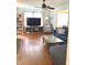 Bright living room with hardwood floors, ceiling fan, bookshelves, and large window at 310 S Butler Ave, Indianapolis, IN 46219