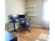 This office features a sleek black desk with modern computer setup and convenient floating shelving at 310 S Butler Ave, Indianapolis, IN 46219