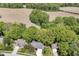 An aerial view of the home nestled amidst trees and expansive fields, with neighboring houses nearby at 310 Wellington Overlook, Noblesville, IN 46060
