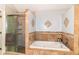 Bathroom showcasing tile floors, glass shower, soaking tub, tiled walls and decorative accents at 310 Wellington Overlook, Noblesville, IN 46060