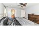 Bedroom featuring neutral walls, carpeted floor, ceiling fan, large bed and a dark-stained dresser at 310 Wellington Overlook, Noblesville, IN 46060