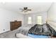 Bedroom with neutral walls, carpeted floor, ceiling fan, large bed and a dark-stained dresser at 310 Wellington Overlook, Noblesville, IN 46060