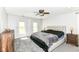 Bedroom with neutral walls, carpeted floor, ceiling fan and large bed with padded headboard at 310 Wellington Overlook, Noblesville, IN 46060