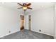 Bright bedroom showcases soft gray carpeting, ceiling fan, and closet access at 310 Wellington Overlook, Noblesville, IN 46060