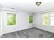 Sunlit bedroom offers plush gray carpeting and large windows with green views at 310 Wellington Overlook, Noblesville, IN 46060
