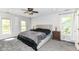 Bedroom with carpeted floor, neutral walls, ceiling fan and large bed with lamps on each nightstand at 310 Wellington Overlook, Noblesville, IN 46060