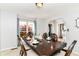 Dining room with a wooden table, ornate chairs, and large window with natural light at 310 Wellington Overlook, Noblesville, IN 46060