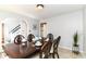 Dining room with a wooden table, ornate chairs, and access to an entryway at 310 Wellington Overlook, Noblesville, IN 46060