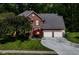 Two-story brick home with an attached garage and a landscaped yard at 310 Wellington Overlook, Noblesville, IN 46060