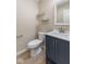 Bathroom featuring a modern vanity with a white countertop, toilet and shelves at 3119 Earlswood Ln, Indianapolis, IN 46217