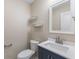 Bathroom featuring a modern vanity with a white countertop, toilet and shelves at 3119 Earlswood Ln, Indianapolis, IN 46217