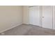 Bedroom showcasing neutral walls, carpet floors, closet and a white door at 3119 Earlswood Ln, Indianapolis, IN 46217