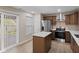 Updated kitchen with stainless steel appliances, center island, wood cabinets, and access to the backyard at 3119 Earlswood Ln, Indianapolis, IN 46217