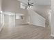 Bright living room features vaulted ceilings, wood flooring, a ceiling fan, and a view to the kitchen at 3119 Earlswood Ln, Indianapolis, IN 46217