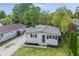 Aerial view of a home, showcasing the well-maintained lawn, long driveway, detached garage, and mature trees at 316 S Roena St, Indianapolis, IN 46241
