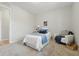 Cozy bedroom featuring a twin bed with white bedding and cool-toned accents and a comfortable white armchair at 316 S Roena St, Indianapolis, IN 46241