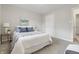 Inviting bedroom featuring a comfortable bed, soft carpet, and neutral decor at 316 S Roena St, Indianapolis, IN 46241