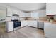 Bright kitchen featuring white cabinets, butcher block countertops, and stainless steel appliances at 316 S Roena St, Indianapolis, IN 46241