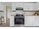 Well-lit kitchen boasting white cabinets, butcher block countertops, and stainless steel oven at 316 S Roena St, Indianapolis, IN 46241