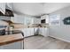 Bright kitchen featuring white cabinetry, butcher block countertops, and modern appliances at 316 S Roena St, Indianapolis, IN 46241