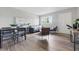 Open concept living room and dining area with modern decor, hardwood floors, and lots of light at 316 S Roena St, Indianapolis, IN 46241