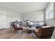 Cozy living room featuring wood floors, a comfortable sofa, chairs, and a dining area at 316 S Roena St, Indianapolis, IN 46241