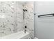 A newly renovated bathroom features marble tiling and a shower with a tub at 3241 Ruckle St, Indianapolis, IN 46205