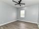 An empty bedroom showcasing the light wood flooring and modern ceiling fan at 3241 Ruckle St, Indianapolis, IN 46205