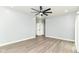An empty bedroom showcasing the light wood flooring and modern ceiling fan at 3241 Ruckle St, Indianapolis, IN 46205