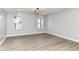 Spacious bedroom with wood-look floors, neutral walls, two windows and a modern light fixture at 3241 Ruckle St, Indianapolis, IN 46205