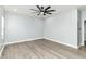 An empty bedroom showcasing the light wood flooring and modern ceiling fan at 3241 Ruckle St, Indianapolis, IN 46205