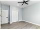 A serene bedroom features hardwood floors, soft gray walls, and a modern ceiling fan at 3241 Ruckle St, Indianapolis, IN 46205