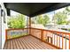 Wooden deck with railings overlooking lush green trees and neighborhood at 3241 Ruckle St, Indianapolis, IN 46205