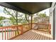 A deck with wooden railing is set under the black canopy of a roof overhang at 3241 Ruckle St, Indianapolis, IN 46205