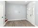 Light-filled entryway with modern gray walls, wood-look floors, and a white door with decorative glass at 3241 Ruckle St, Indianapolis, IN 46205