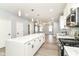Bright kitchen features an island with quartz countertops, stainless steel appliances, and pendant lighting at 3241 Ruckle St, Indianapolis, IN 46205