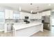 Stylish kitchen featuring white cabinets, stainless steel appliances, and a large center island with quartz countertop at 3241 Ruckle St, Indianapolis, IN 46205