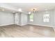 Open living room with light gray walls, wood-look floors, and natural light flowing from multiple windows at 3241 Ruckle St, Indianapolis, IN 46205