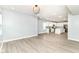 Bright and airy living area with wood-look floors flowing into a modern kitchen with white cabinets at 3241 Ruckle St, Indianapolis, IN 46205