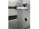 Modern shower featuring white tile, sleek black fixtures, and a recessed shower niche at 336 W 29Th St, Indianapolis, IN 46208