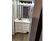 Bathroom vanity with white countertop, double sinks, black faucets and a large mirror with modern lighting at 336 W 29Th St, Indianapolis, IN 46208