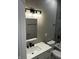 Contemporary bathroom with white vanity, black fixtures, and modern lighting fixture at 336 W 29Th St, Indianapolis, IN 46208