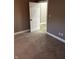 A cozy carpeted bedroom features neutral walls and a glimpse into an adjacent room with hardwood floors at 336 W 29Th St, Indianapolis, IN 46208
