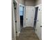 Hallway showcasing wood-look flooring and white doors leading to bedrooms and bathrooms at 336 W 29Th St, Indianapolis, IN 46208