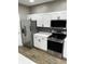 The kitchen includes white cabinets, stainless steel appliances, and tiled backsplash at 336 W 29Th St, Indianapolis, IN 46208