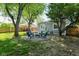 Large backyard featuring mature trees and a fire pit area creating a relaxing outdoor space at 3608 Valley Lake Dr, Indianapolis, IN 46227