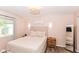 A cozy bedroom featuring neutral tones, a comfortable bed, and a decorative light fixture at 3608 Valley Lake Dr, Indianapolis, IN 46227